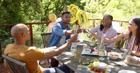 Friends Celebrating 30th Birthday Outdoors with Cakes and Drinks