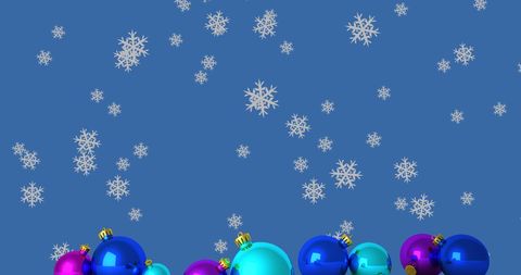 Falling Snowflakes Over Festive Christmas Baubles on Blue Background