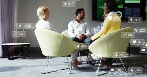 Colleagues Collaborating in Modern Office Meeting Analyzing Social Media Metrics and Strategy