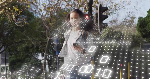 Young woman walking with phone at intersection with digital binary data ar grid overlay