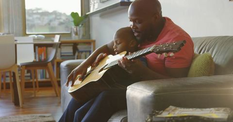 Father and Son Bonding Time Playing Guitar Together