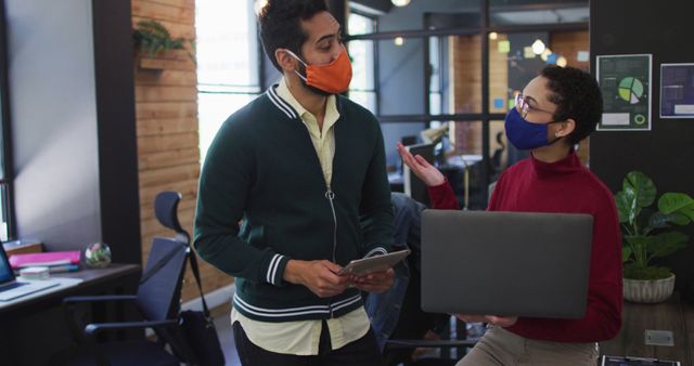 Office workers wearing masks discussing in modern workspace - Download Free Stock Images Pikwizard.com