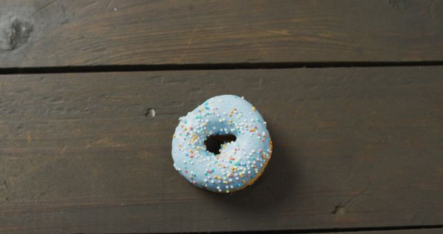 Single Blue Iced Donut with Sprinkles on Wood Surface - Download Free Stock Images Pikwizard.com