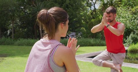 Outdoor Yoga Session with Instructor and Student in Park Setting