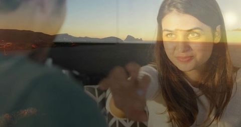 Romantic evening couple on balcony overlooking sunset sea