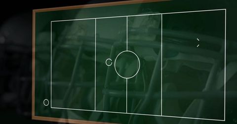 Displaying chalkboard football play diagram with helmet reflections and wood frame