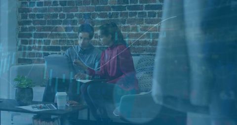 Team Analyzing Financial Data Over Digital Display in Modern Office