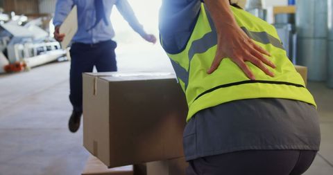 Warehouse Worker Experiencing Back Pain Lifting Heavy Box - Download Free Stock Images Pikwizard.com