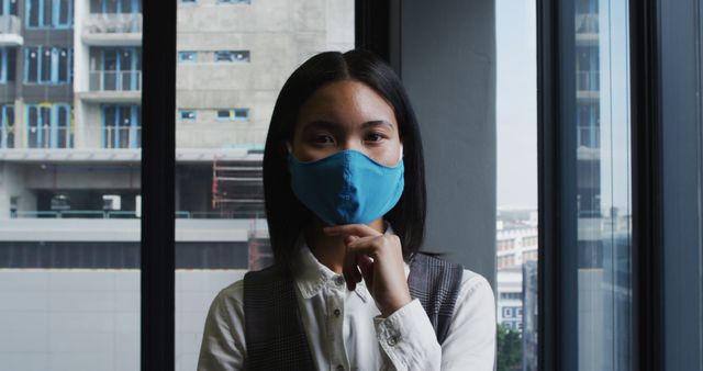 Woman Wearing Blue Face Mask in Office Building - Download Free Stock Images Pikwizard.com