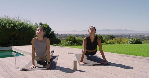 Diverse Women Embracing Outdoor Yoga for Health and Wellness