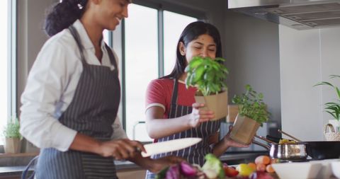 Two Friends Enjoy Cooking Plant-Based Meal Together - Download Free Stock Images Pikwizard.com