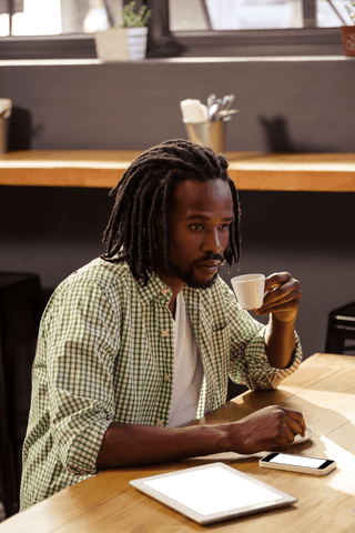 man with coffee cup and tablet at wooden table, pondering ideas - Download Free Stock Videos Pikwizard.com