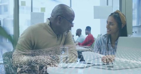 Senior Mentor and Young Professional Collaborating in Modern Office