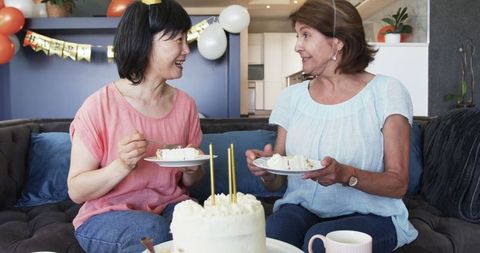 Senior Women Celebrating Birthday with Cake and Conversation