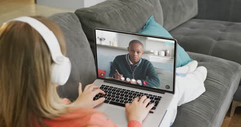 Modern Education: Two Students Video Conferencing on Laptop
