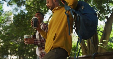 Bipoc Friends Enjoying Coffee and Backpacking in City Park