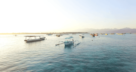 tranquil boats on transparent lake during serene sunset - Download Free Stock Videos Pikwizard.com
