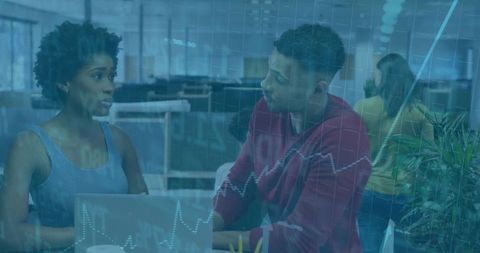 Business Colleagues Analyzing Digital Graphs in Modern Office