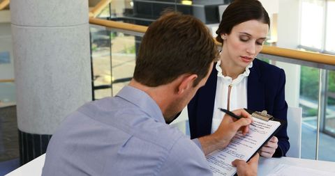 Business Professionals Reviewing Important Document in Meeting - Download Free Stock Images Pikwizard.com