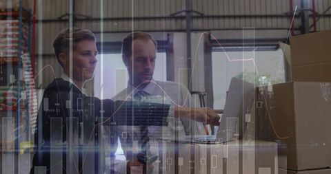 Warehouse Workers Analyzing Financial Data on Laptop - Download Free Stock Images Pikwizard.com