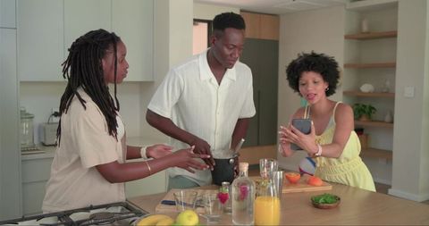 African American Friends Preparing Brunch and Making Fresh Juice in Bright Modern Kitchen