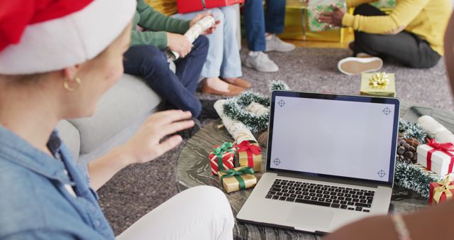 Friends smiling and interacting with loved ones via laptop, celebrating Christmas with a virtual gift exchange. Ideal for illustrating modern holiday celebrations, remote gatherings, and online party concepts.