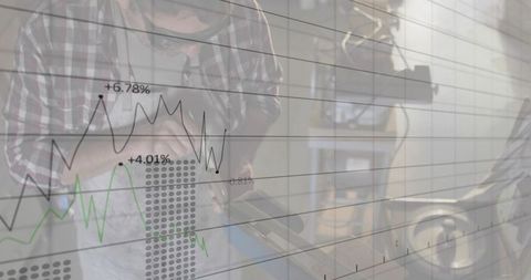 Experienced mechanic repairing wheel on bench with financial data overlay double exposure