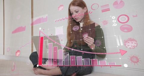 Young woman making online payment holding credit card analyzing holographic charts
