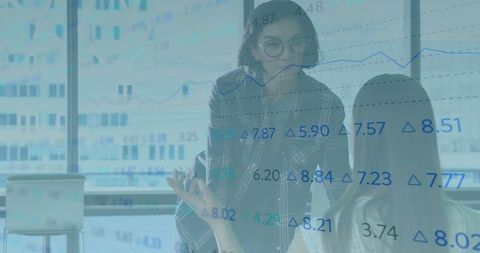 Professional women analyzing financial data in business setting