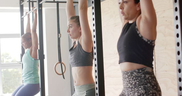 Focused Women Practicing Pull-ups in a Gym - Download Free Stock Images Pikwizard.com