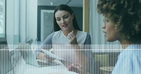 Business Women Collaborating on Project at Modern Office