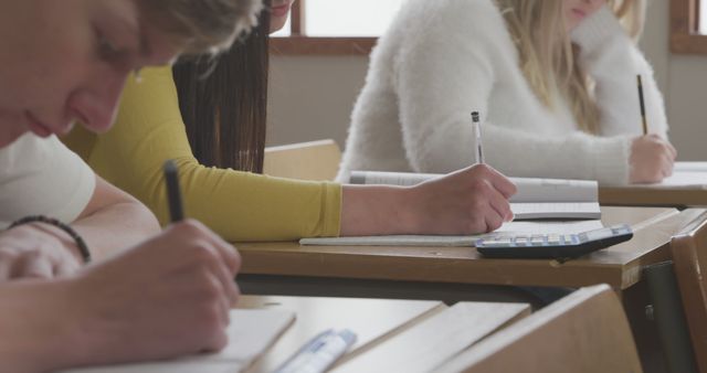 Students Writing Notes in Classroom with Calculators on Desks - Download Free Stock Images Pikwizard.com