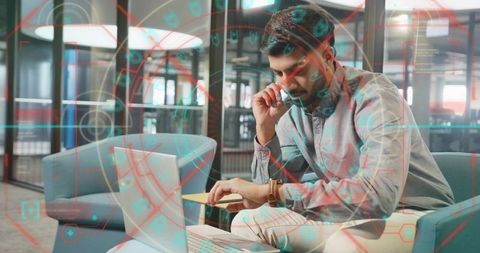 Thoughtful Professional Using Laptop in Modern Office Setting