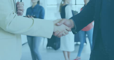 Business Handshake Among Colleagues in Office Environment