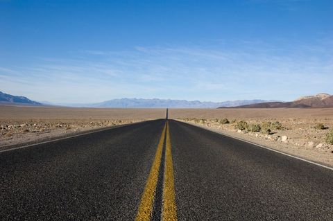 Desert highway road stretching into horizon