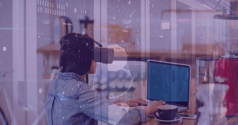 Young Woman Using VR Headset and Laptop in Urban Cafe