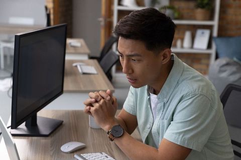 Focused Young Professional Working In Modern Office Setting