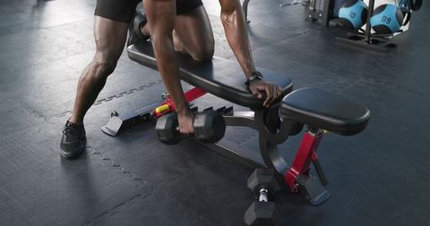Muscular Athlete Exercising Dumbbell Row in Fitness Gym Health Training