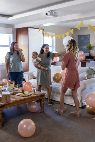 Diverse Group Celebrating Together in Comforting Living Room