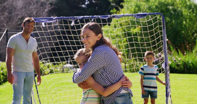 Happy Family Enjoying Playing Soccer Together Outdoors - Download Free Stock Images Pikwizard.com