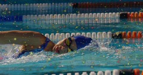 Female Swimmer in Motion with Vibrant Particle Effect Highlighting Performance