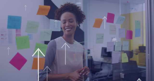 Smiling Businesswoman Planning Ideas with Sticky Notes on Glass Wall - Download Free Stock Images Pikwizard.com