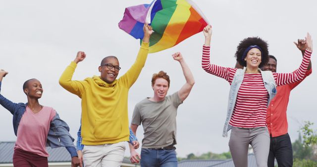Happy group of diverse male and female protesters walking with rainbow flag - Download Free Stock Photos Pikwizard.com