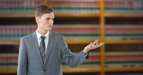 Confident lawyer presenting argument in courtroom library