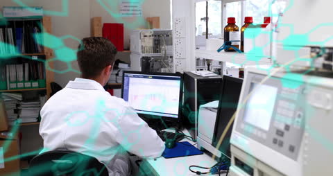 Scientist Analyzing Data on a Computer in Modern Laboratory