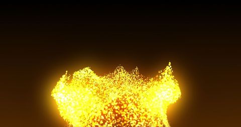 Golden glowing particles effervescing against black background