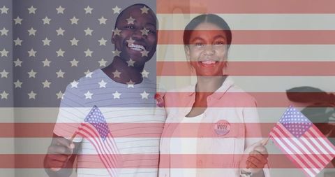 Diverse couple smiling with flags and vote badges symbolizing civic engagement