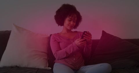 Young Woman Relaxing on Couch with Smartphone Home Comfort Vibe
