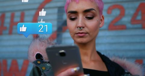 Young Woman Engaged in Social Media on Smartphone Outdoors