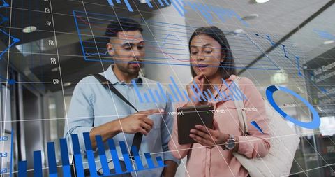 Professionals analyzing data charts in modern airport environment